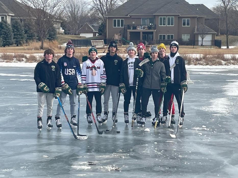 Some of the Sioux City Metros hockey team, including Dakota Valley junior Grant Harder and Dakota Valley freshmen Noah Graham take advantage of the ice-covered pond at Wynstone over the holiday break. Submitted photo