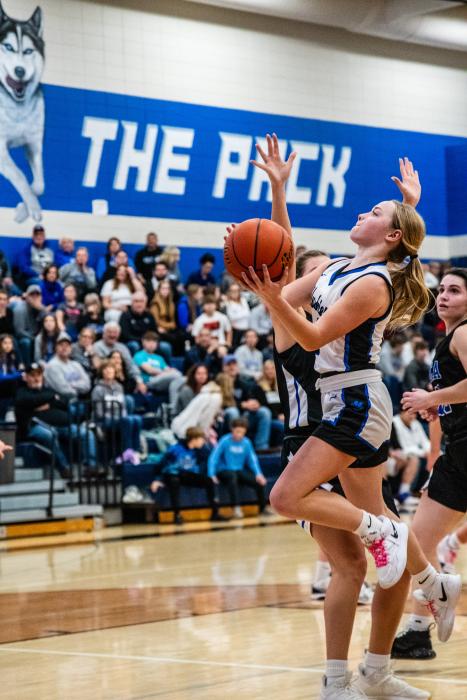 Kaitlyn VanRoekel draws contact as she goes up for the lay-up. Photo by Peterman Sports Photography stevepeterman5@gmail.com