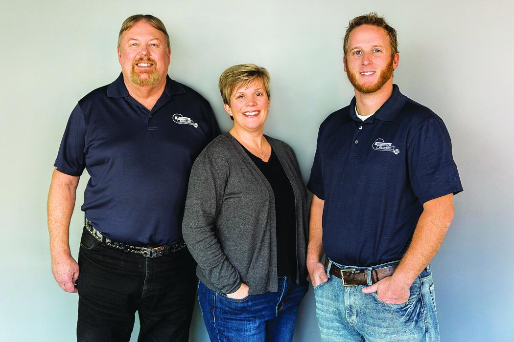 Dave Mitchell, Darcie (Mitchell) KIstner and Dallas Mitchell pose for a family business photo. Mitchell Electric celebrated 10 years in business Jan. 9. Darcie Kistner and, her mother, Debbie Mitchell (not pictured) are co-owners in the family-oriented, woman-owned business. Photo courtesy of Suing Studios