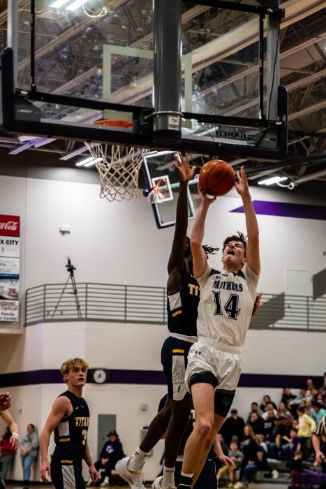 Senior Sam Faldmo goes up for two of his hard-earned 12 points againstTea Area. Photo by Peterman Sports Photography stevepeterman5@gmail.com