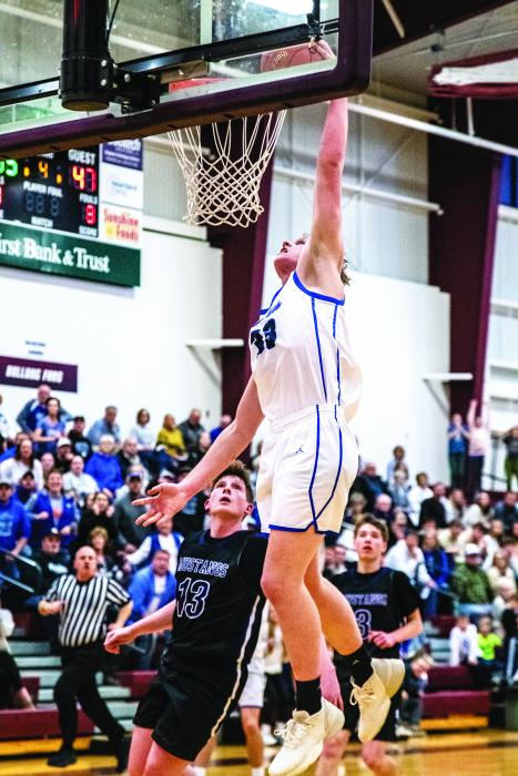 Evan Fornia goes up for the dunk against Waubay/Summit on March 9. Fornia had 13 points during the contest. Photo by Peterman Sports Photography stevepeterman5@gmail.com