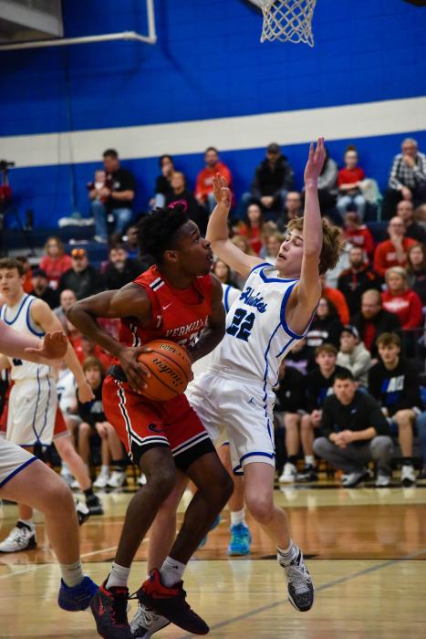 Kayden Moore takes a charge from Vermillion’s Zoan Robinson. Photo by Peterman Sports Photography stevepeterman5@gmail.com
