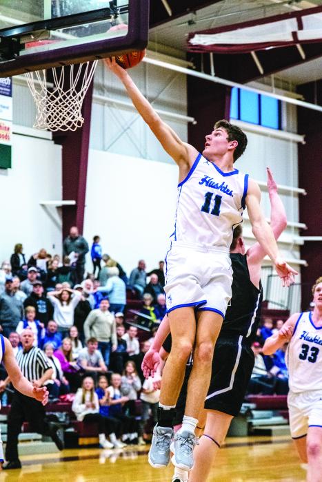 Jakob Scarmon shows his height as he stretches to lay the ball softly into the hoop. Photo by Peterman Sports Photography stevepeterman5@gmail.com