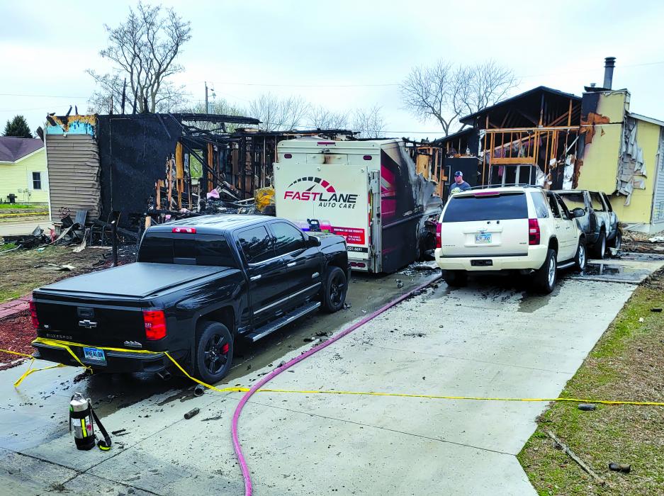 Pictured are two of the homes involved in Tuesday night’s fire. The house on the left was the initial house fire that damaged two other homes. The home on the right is one of the homes damaged by fire. Four vehicles, parked in the driveway, were also damaged in the fire. Photo courtesy of North Sioux City Fire Department