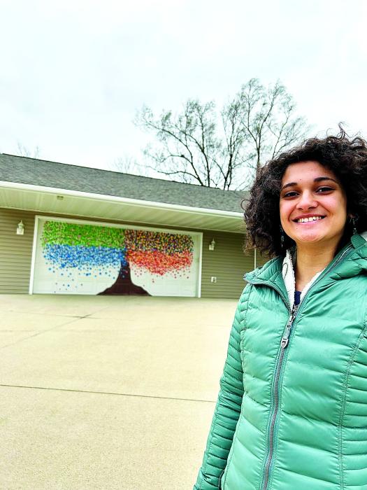 Izzy Curry spent the summer of 2020 painting a four-season tree on the garage of her aunt’s house. Photo submitted