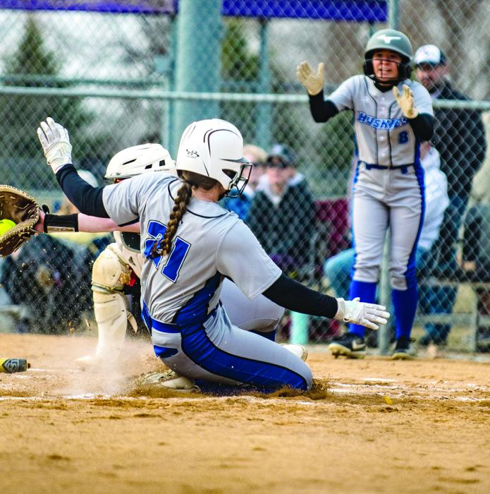 Josie Curry slides into home while Sophia Giorgio cheers her on. Photo by Peterman Sports Photography stevepeterman5 @gmail.com