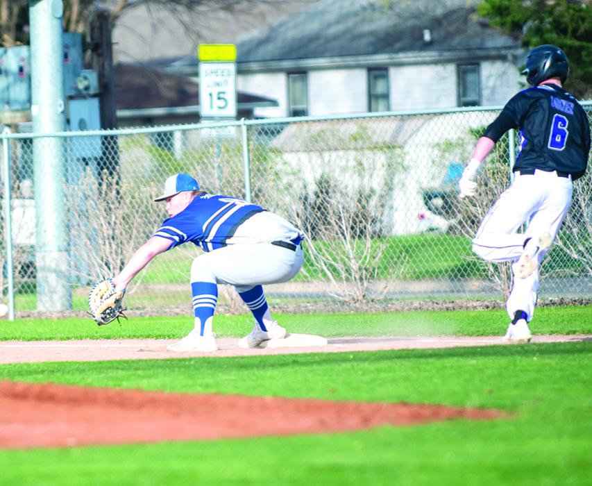 Ty Trometer crouches to catch a low pass as DVs Drew Lukken races to reach 1st base. Trometer was able to secure the out. Photo by Peterman Sports Photography • stevepeterman5@gmail.com
