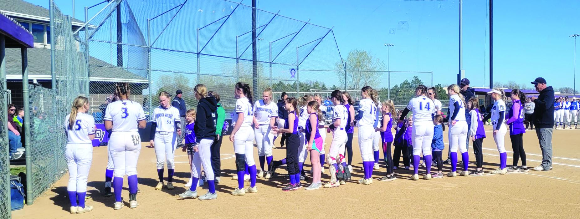 It was Dakota Valley youth softball night at the ballpark on May 1 for the Panther’s home game. Young softball players, in elementary school and middle school, were invited to wear their local DV jerseys to the game for free admittance. DVHS softball players lined up with the young athletes for the starting line-ups to be announced. Each member of the varsity roster was escorted by a younger player prior to the first pitch. Photo by Kelly Riibe times2reporter@gmail.com