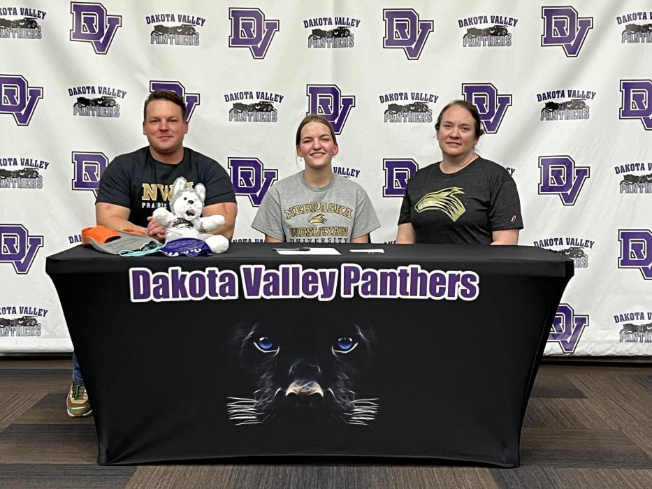 Emily Carlson, middle, signed with Nebraska Weselyan University to participate in their swimming program. She was surrounded by her parents, Mark and Susan Carlson, and other family members and friends when she signed April 28. Submitted photo
