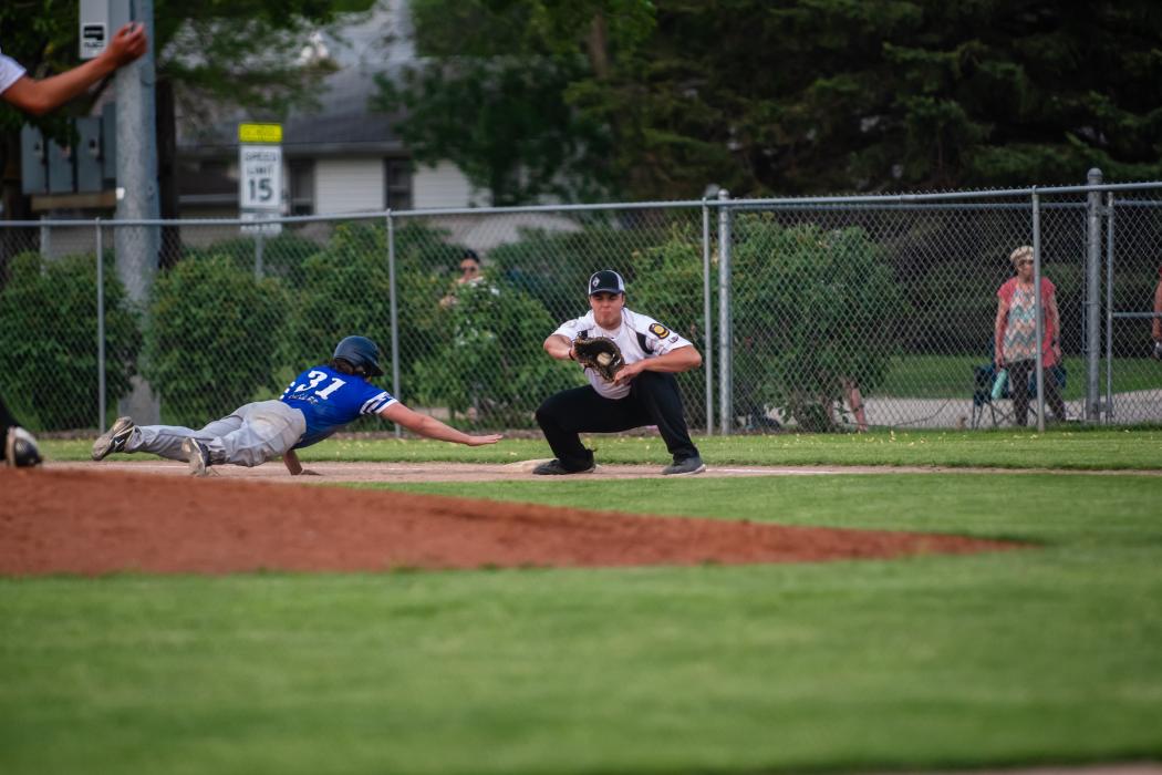 Christian Mueller stretches back to first base after the Beresford/Alcester-Hudson pitcher tested Mueller. He was called safe due to the first baseman not having his foot completely on the base. Photo by Peterman Sports Photography • stevepeterman5@gmail.com