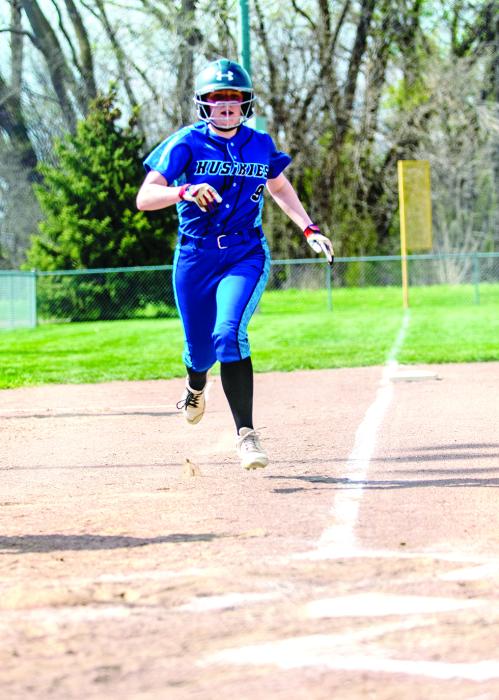 Grace Schuh crosses home plate to score for the Huskies. Photo by Peterman Sports Photography stevepeterman5@gmail.com
