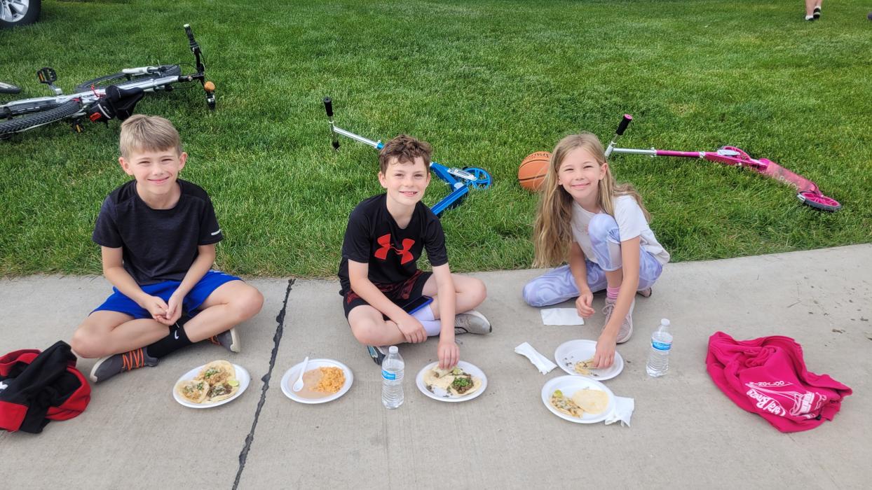 These three (L-R), Liam O’Carroll, Bennett Wetz and Maeve O’Carroll enjoyed the nice weather, fun atmosphere and good food at 'Food Trucks in the Park' on Sunday, June at the Prairie Park in Dakota Dunes. They enjoyed food from Taqueria El Buen Gusto. Photo by Kelly Riibe • times2reporter@gmail.com