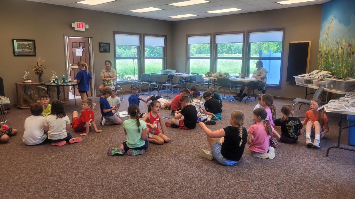 Campers from the “Pioneer Fun” camp at Adams Homestead and Nature Preserve convene in the visitor center at the end of the day on Tuesday, June 13.