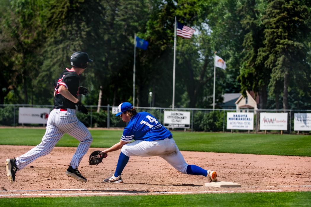  Jordan Anderson stretches to make the out at 1st base.Ben Swatek makes a base hit. Photo by Peterman Sports Photography • stevepeterman5@gmail.com