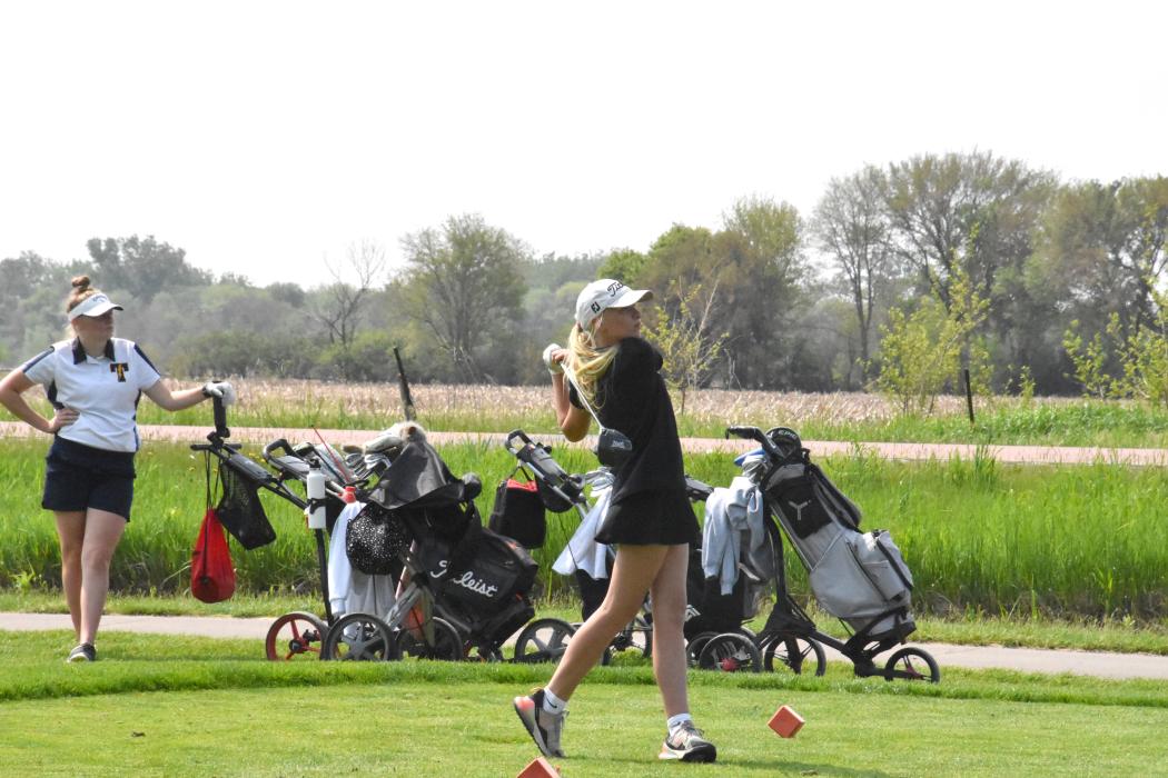 Katie Betsworth watches where her ball lands off her tee off during the conference meet in Vermillion May 22.