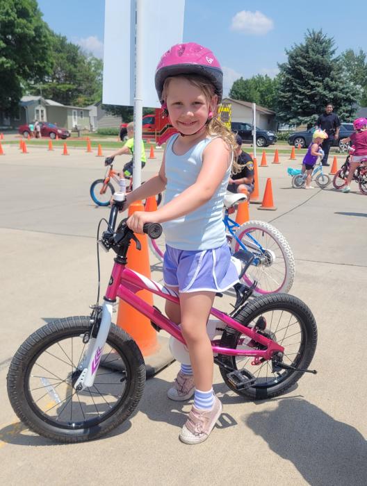 Harper Moss, of Dakota Dunes, enjoyed the obstacle course for bike riders at the NSC Library’s Summer Reading Kick-off Event on June 6, 2023. Photo by Kelly Riibe  times2reporter@gmail.com