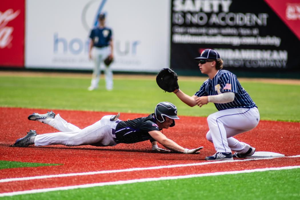 Jaxon Hennies dives back to first base during state tournament May 29. He beat the ball back to the base to be called safe. Photo by Peterman Sports Photography • stevepeterman5@gmail.com