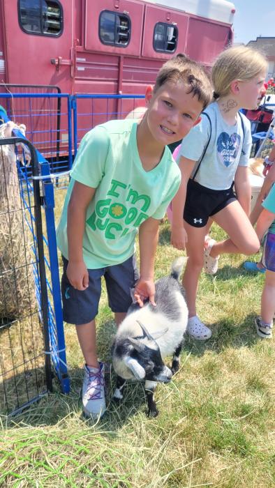 Oliver Scott, of River-R-Land in North Sioux City, pets a baby goat while at the NSC Library’s summer reading bike rodeo and kick-off event. Photo by Kelly Riibe times2reporter@gmail.com