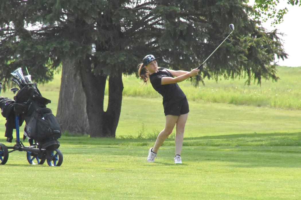 Addicyn Sailer concentrates as she tees off in the conference meet in Vermillion May 22.
