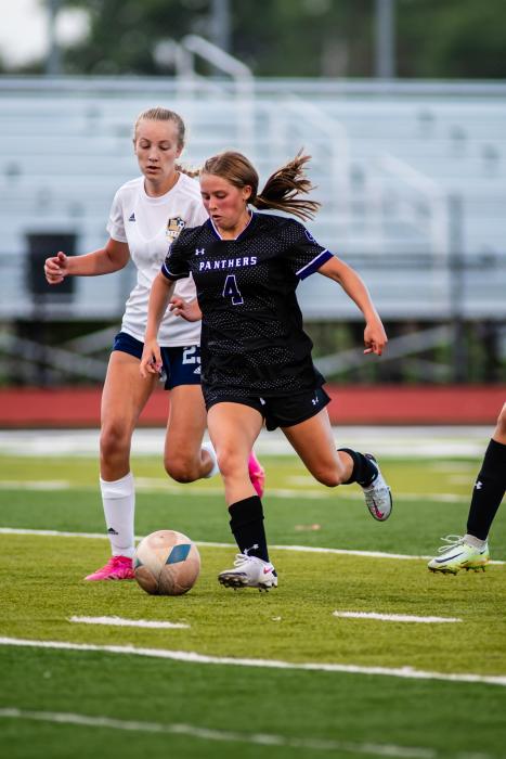 Sophie Meyer works to keep the ball away from the Tea Area defender in their first game of the season on Aug. 11.