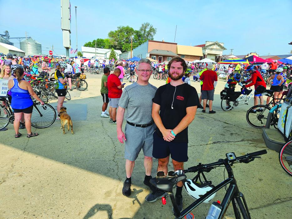 Johnny Tureaud and Dominick Tureaud take a quick picture during the RAGBRAI stop in Kingsley, IA.