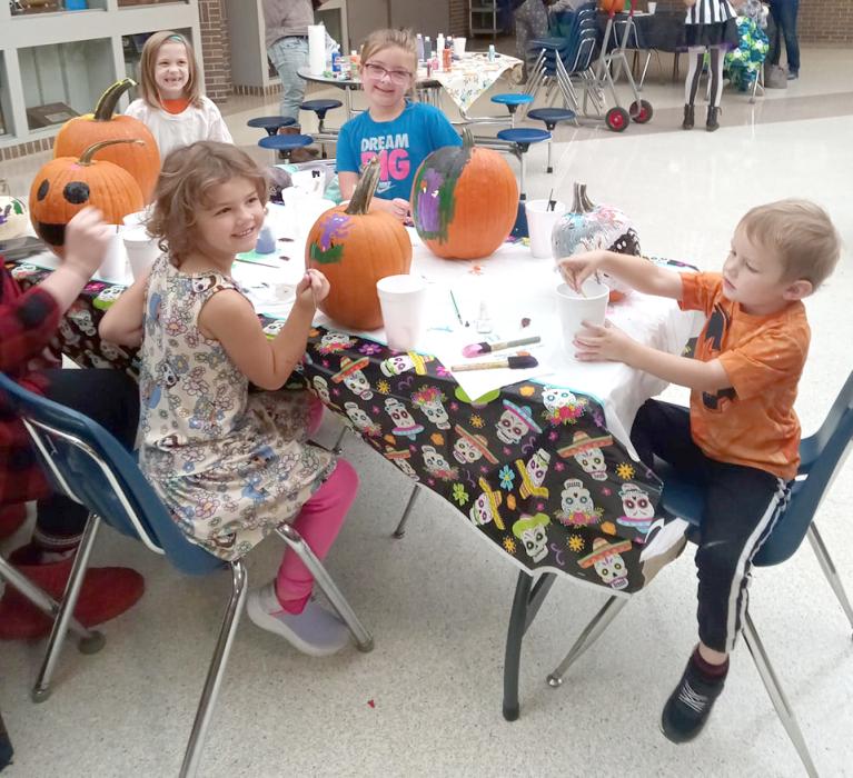 Children gathered at the Elk Point Library to paint pumpkins on Oct. 28. They are all smiles as they use their imagination to paint their pumpkins all sorts of colors, with faces or with other scary monsters.