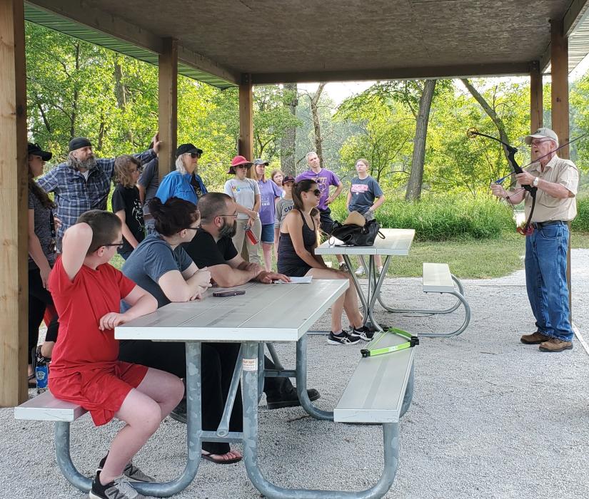 Norb Ruhland is pictured here, at right, teaching a class on archery and how to notch an arrow. Submitted photo