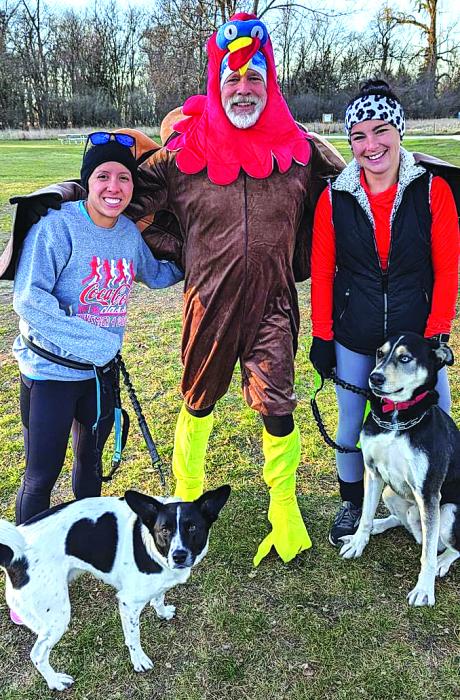 Phil Breed, middle, was ready for the Turkey Trot held at Adams Homestead and Nature Preserve Nov. 23. Pictured with Breed are, left, Rheanne Hoffman with her dog, Sadie, and, right, Courtney Leaverton with her dog, Luke. Submitted photo
