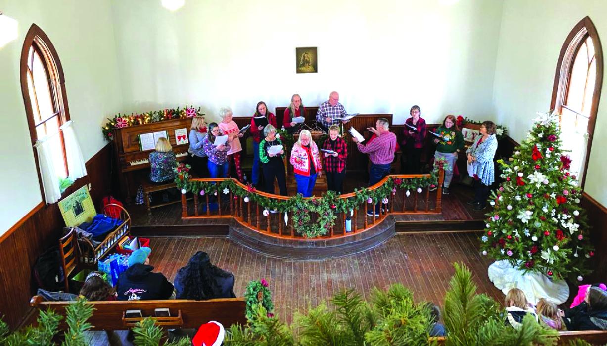People sang Christmas Carols inside the Stavenger Lutheran Church during Christmas at the Homestead Nov. 11 at Adams Homestead and Nature Preserve. Submitted photo