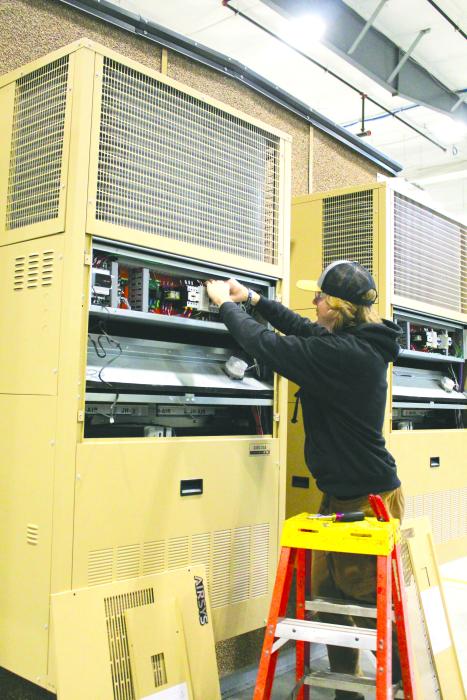 Jayse Vande Vegte works on an electrical unit attached to one of Thermo Bond’s structures. He is interning with Thermo Bond and hopes to use his new found skills to become an electrician. Photo by Beth Hutcheson • times1reporter@gmail.com
