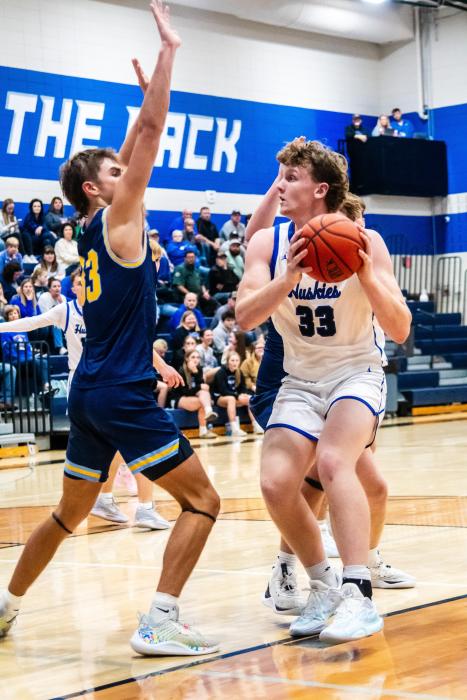 Evan Fornia, pictured here against Canton, had a spectacular game under the hoop in Madison Dec. 9. He scored 13 points for the Huskies had 7 rebounds, 3 assists and 2 steals. Photo by Peterman Sports Photography • stevepeterman5@gmail.com
