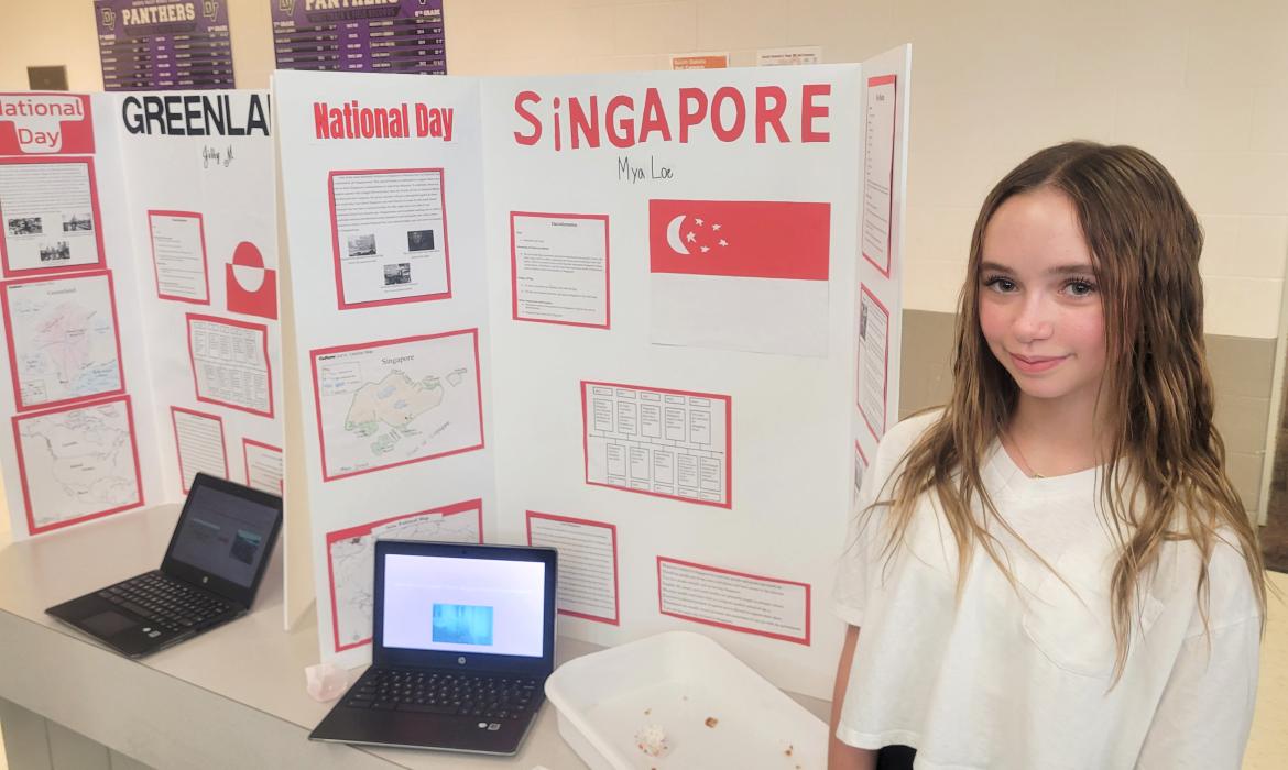 Mya Loe, of Dakota Dunes, shared facts about Singapore and also offered samples of sugee cake which is a popular dessert in the country. Photo by Kelly Riibe • times2reporter@gmail.com