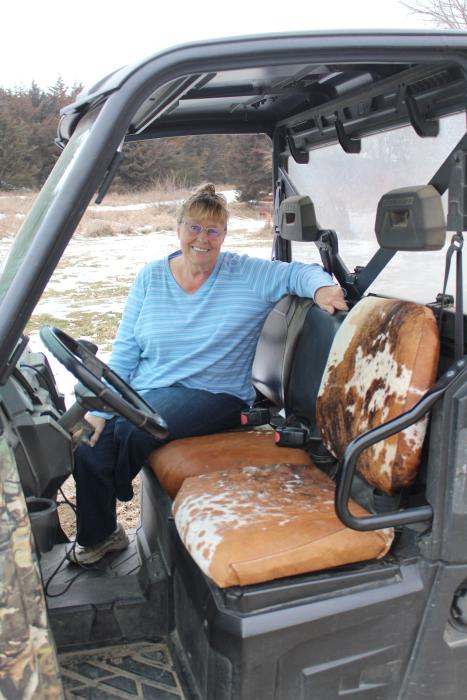 Char Campbell of rural Elk Point has opened her business Artsy Fartsy and enjoys the challenge of upholstery. Recently she reupholstered her ATV with cowhide seats. Photo by Beth Hutcheson • times1reporter@gmail.com