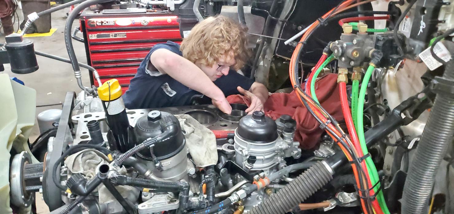 Elk Point-Jefferson senior Johnathan Kjose works on replacing the oil in a semi-tractor. Submitted photo