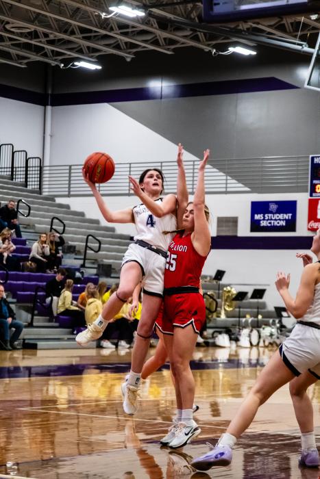 Emersen Mead shows tenacity as she shoots over a Vermillion defender Feb. 6. Photo by Peterman Sports Photography stevepeterman5@gmail.com