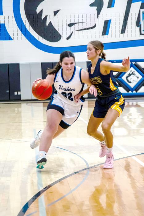 Courtney Brewer shows grit as she dribbles into a Titan defender Feb. 16. Photo by Peterman Sports Photography stevepeterman5@gmail.com