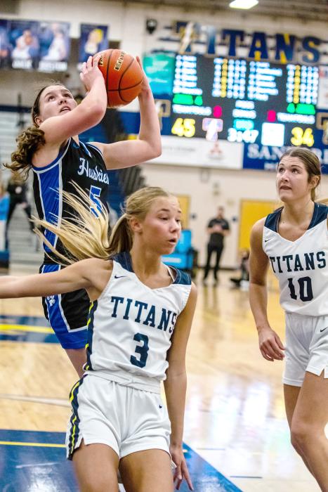 Cera Schmitz attacks the basket and gets 2 of her 16 points against the Titans on Feb. 22.