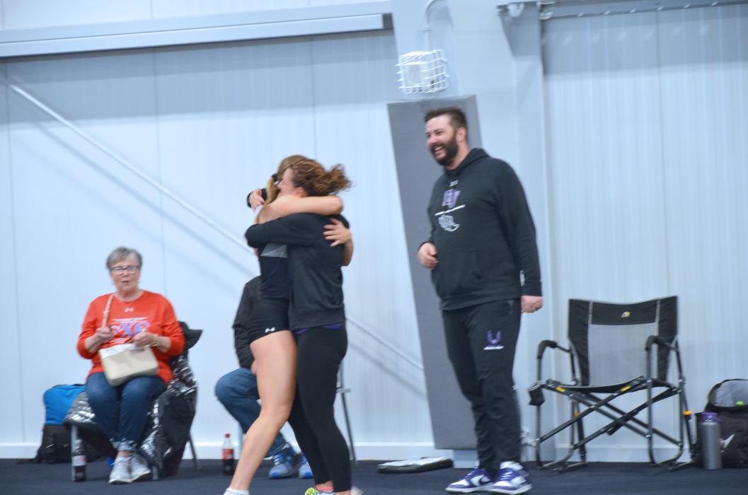 DV Track Coaches Tammy Lilly gives Silja Gunderson a hug and James Schmit congratulates her after she won the 60m dash at Mount Marty. Gunderson also took 1st in the 60M hurdles on March 21. Photo by Kelly Riibe •times2reporter@gmail.com