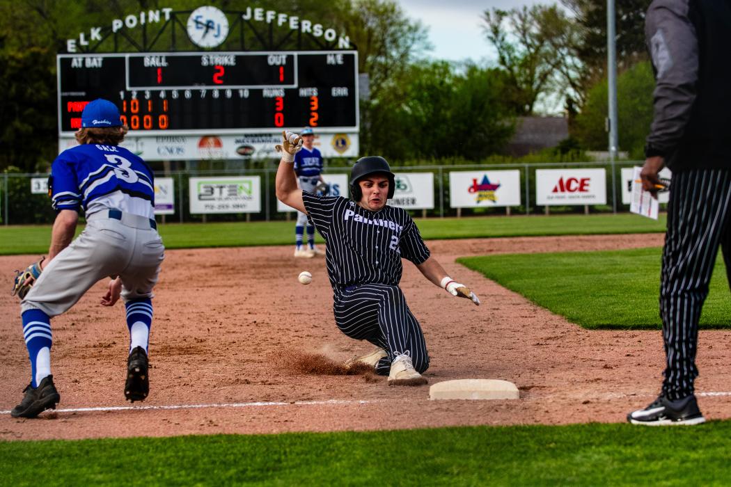 Brendan Barnett slides safely into 3rd during the Panther win over the Huskies. Photo by Peterman Sports Photography • stevepeterman5@gmail.com