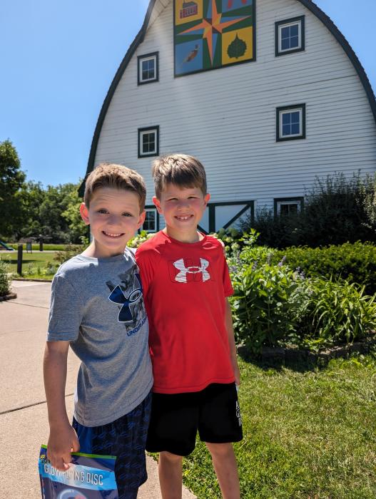 From left Jamison Moore and Ty Ledgerwood, both of Elk Point, traveled to North Sioux City for summer camp at the Adams Homestead & Nature Preserve on June 11-13. They are seen here outside of the visitor center after a full morning of activities.     Photo by Kelly Riibe • times2reporter@gmail.com