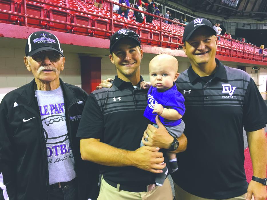 Four generations of VanDenHuls took in DV’s championship football game at the DakotaDome in 2017. Jeff and his son Josh were on the sidelines while Jeff’s dad (George) and grandson (Theo) were in the crowd. From left: Jeff’s dad, George VanDenHul, son Josh who was an assistant coach, grandson Theo, and Jeff at the Championship game in Vermillion.