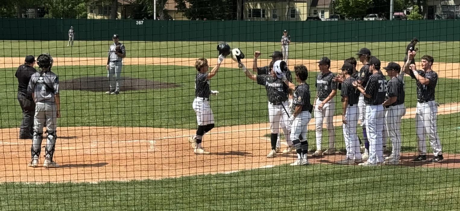 Dakota Valley’s Noah Graham is greeted by teammates after his solo homerun on Friday, June 7th. Submitted photo