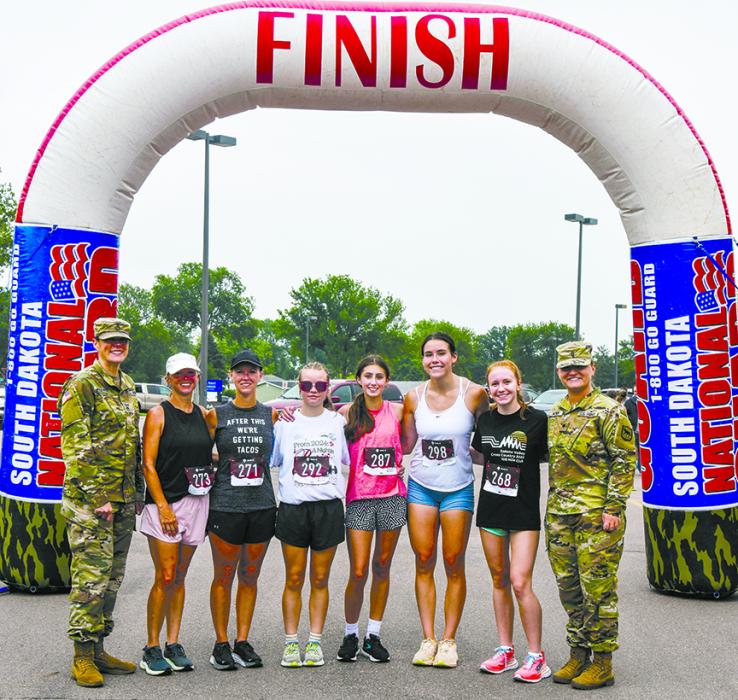 SSG Jessica Anderson (left) and SPC Hannah Huyser (right) join the top five female runners from left to right: Angie Hanson, Laura Robinson, Ashley Stark, Gracelyn Campbell, Calie Davis, and Maylee Rose.