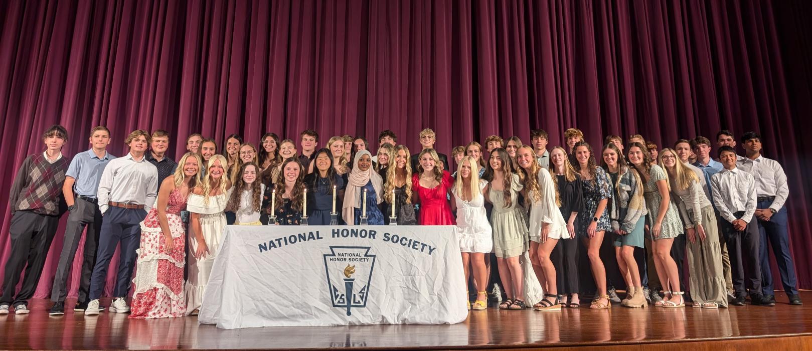 Dakota Valley’s newly inducted NHS members, along with current members, gathered on-stage at the end of the ceremony for a large group photo. Photo by Kelly Riibe • times2reporter@gmail.com