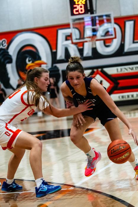 Aubree Worden dribbles around the defender from Lennox on December 10, 2024. Photo by Peterman Sports Photography • stevepeterman5@gmail.com