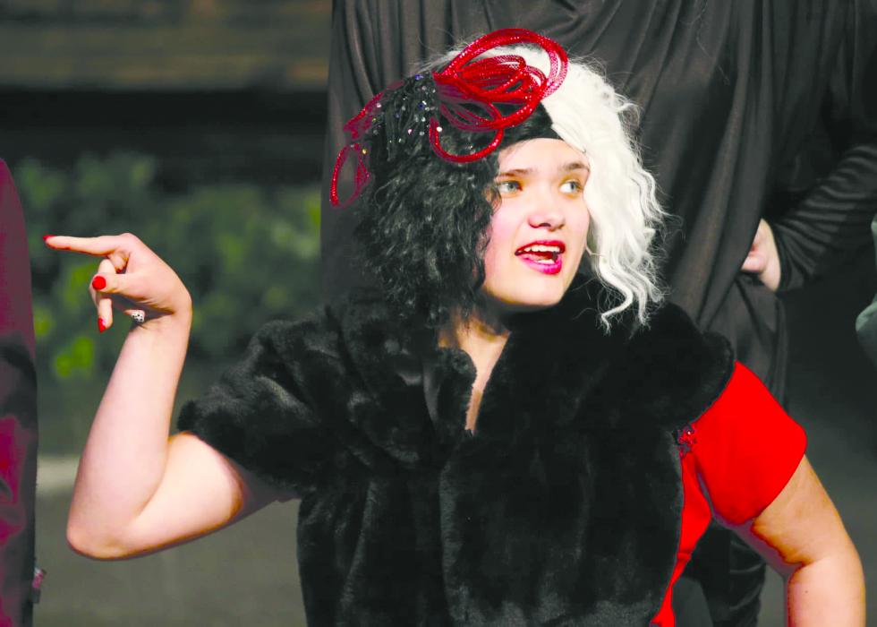 Karlee Hughes, in center dressed as Cruella de Vil, is seen here surrounded by family who loved watching her perform on stage. Submitted photo