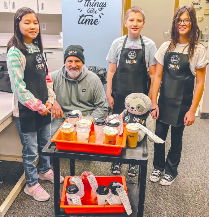 EPJ Students get ready to deliver Union Bean beverages to faculty. Even the class mascot, Steve the Sloth, helps out. Photo contributed