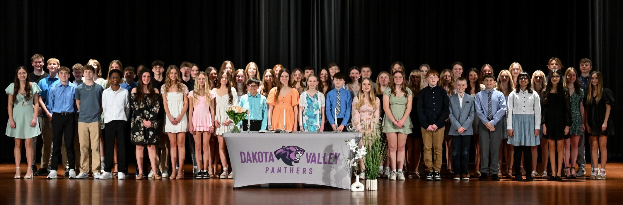 Current and new members of DV’s National Junior Honor Society gathered on stage after the March 3rd induction ceremony. Photo courtesy of Squier Designs