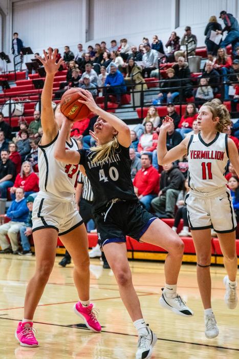 Panther freshman Ella Otten fights through contact for a basket during the DV away game in Vermillion .