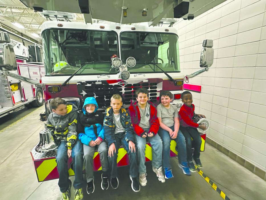Scouts from Pack 28 learned about fire safety and things they can help their parents look for in their homes. After the scouts toured the fire dept, they learned about some of the gear and equipment firefighters use. Pictured: Gavin Carlson, Graham Carlson, Carter Hunt, Kendy Pierre, Blake Winters, and Tucker Winters. Photo submitted